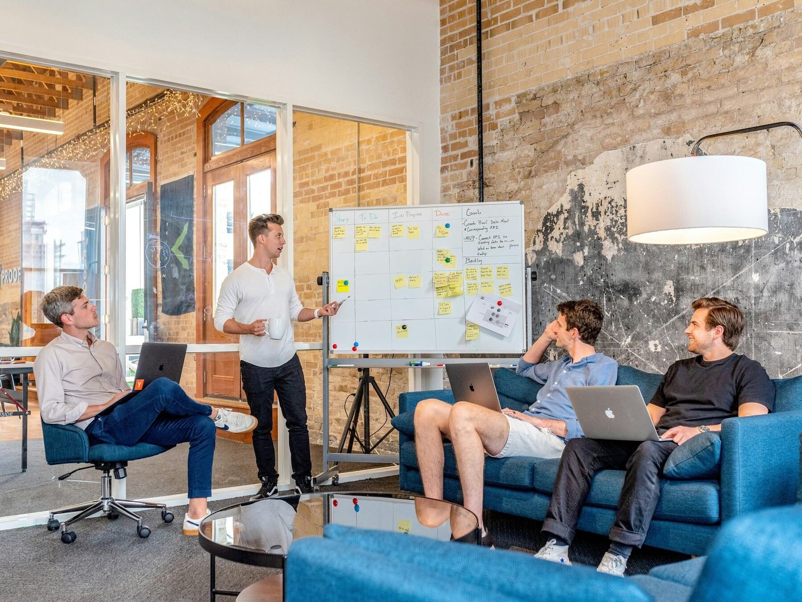 Team planning strategy around a whiteboard